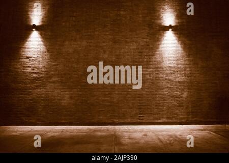 old room with brick wall, grungy background . brick wall with bulb lights lamp. nice brick show room with spotlights. Background of an empty corridor Stock Photo