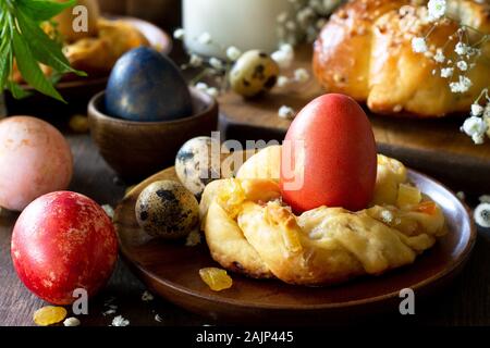 Easter holiday table. Easter cakes and colored eggs close-up on a wooden table. Stock Photo