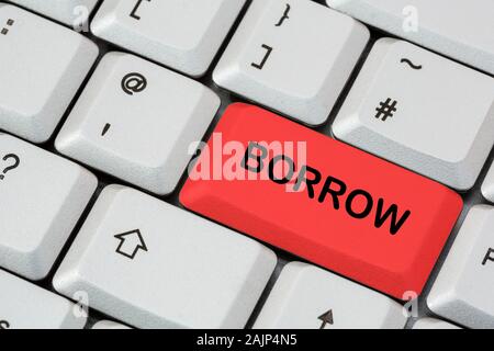 A keyboard with the word Borrow written in black lettering on red enter key. Debt and loan money concept. England, UK, Britain Stock Photo
