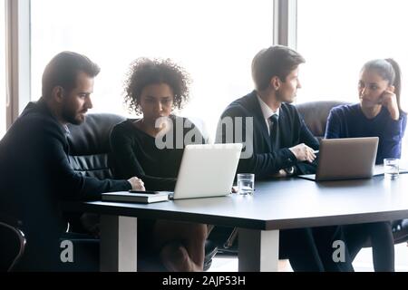 Multiracial businesspeople work together collaborating at meeting Stock Photo
