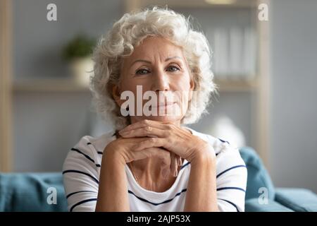 Headshot portrait mature woman posing looking at camera Stock Photo