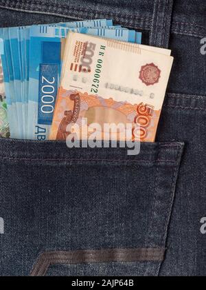 Bunch of Rouble banknotes in the back pocket of a blue jeans. Stock Photo