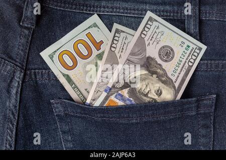 Many dollar 100 banknotes in a back jeans pocket Stock Photo