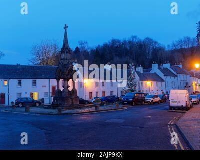 Looking down the High Street and the Cross of Dunkeld, with the Atholl Memorial Fountain and lit up Christmas Tree on New Years Day Evening. Stock Photo