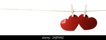 Clothes pegs and red paper hearts on rope isolated on white background ...