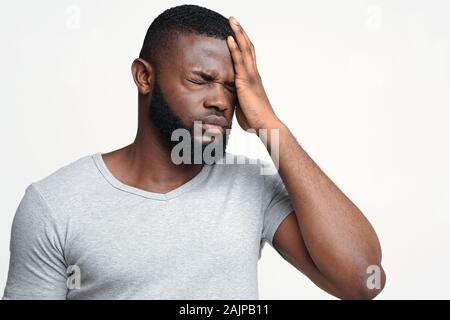 Brain diseases problem cause chronic severe headache. Young black man tired and stressed, having mental problem trouble, medical concept Stock Photo