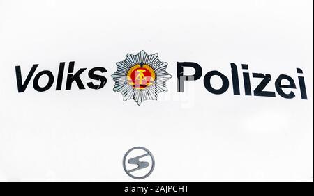 weathered volkspolizei, gdr police force, and trabant logo Stock Photo