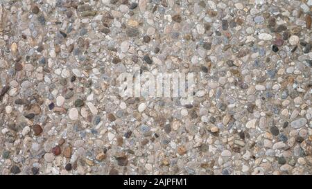 Pebble in concrete path. Top view stone background. Stock Photo