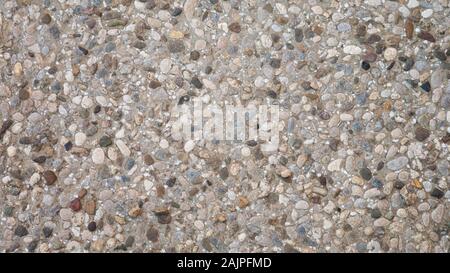 Pebble in concrete path. Top view stone background. Stone paving surface. Stock Photo