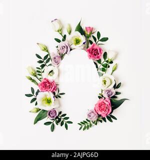 Creative layout egg made of pink flowers and green leaves. Happy easter card. Stock Photo