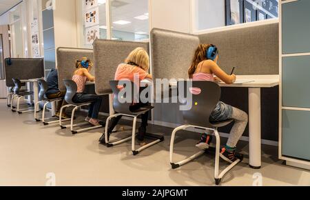 NIJMEGEN / NETHERLANDS-SEPTEMBER 13, 2019: children working concentrated in a modern school environment. They are working alone without a teachers Stock Photo