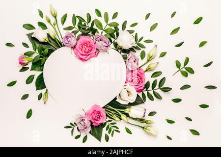 Valentine's day romantic concept. Creative floral heart made of white and pink roses and green leaves. Stock Photo