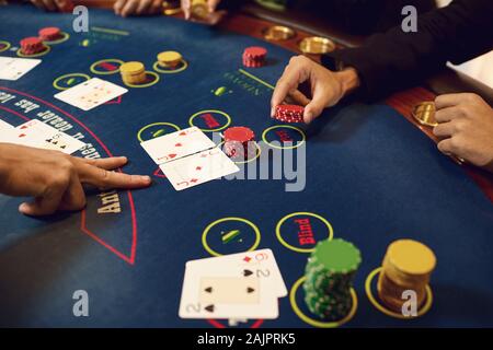 Hands of players and croupiers in the game cards Stock Photo