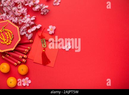 Arrangement decoration Chinese new year or lunar festival background concept. Orange and red packet money also fortune cookies on red Stock Photo