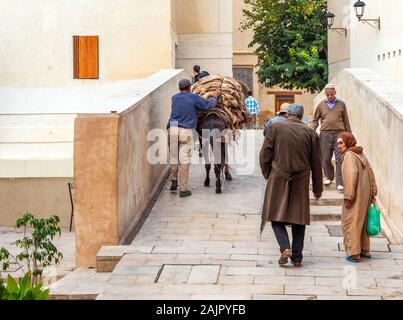 Fes, Morocco - November 12, 2019: People on the street of the old Medina Stock Photo