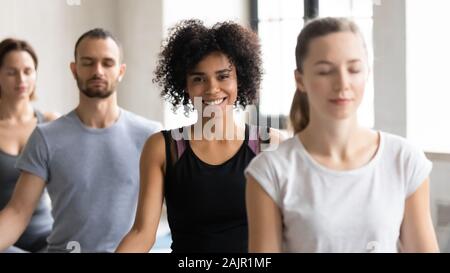 Portrait smiling African American woman at group lesson, practicing yoga Stock Photo