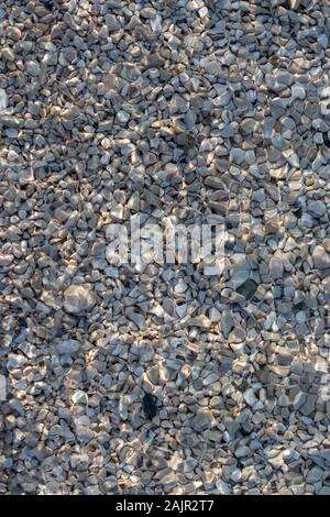 Crstal clear water of the adriatic sea, beach shot. Small white and blue waves on a rocky pebble beach Stock Photo