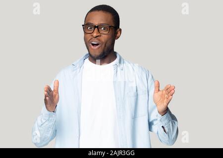African guy stretched hands showing something long studio shot Stock Photo