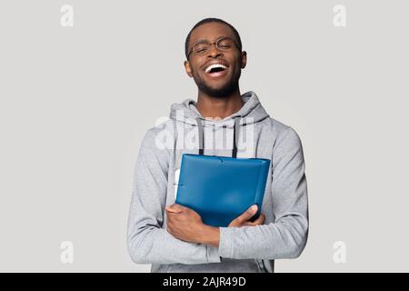 Happy African man keep in hands blue folder studio shot Stock Photo