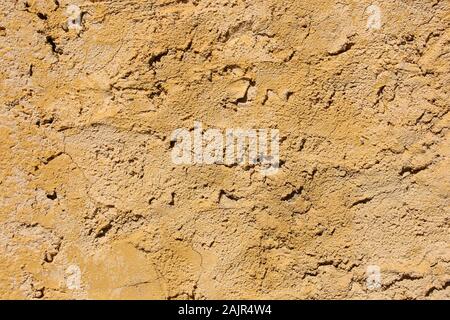 Texture yellow plaster on the old cracked wall Stock Photo