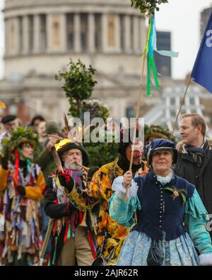 London, UK. 5th Jan 2020. The 25th annual Twelfth Night Celebration, an ancient Midwinter custom, is held at Bankside, performed by 'The Lions part' players. The Holly Man, decked in green foliage, is piped over the River Thames. He is joined by the London Mummers, to toast (wassail) the people, and perform freestyle folk combat play in colourful costumes. The procession moves across the river, to Shakespeare's Globe and on to the St George Inn, Southwark. Credit: Imageplotter/Alamy Live News Stock Photo
