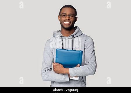 African student holding in hands folder studio shot Stock Photo