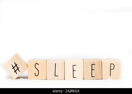 Wooden cubes with a Hashtag and the word Sleep isolated on white background, social media concept space for text Stock Photo
