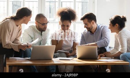 Multiracial millennial students brainstorm studying together at home Stock Photo
