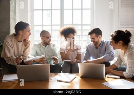 Happy international young people laugh studying indoors Stock Photo