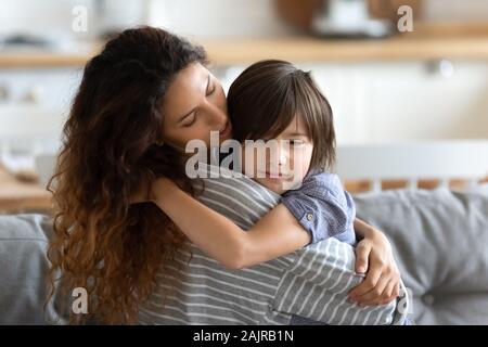 Mom embracing little son express care and love soothing him Stock Photo