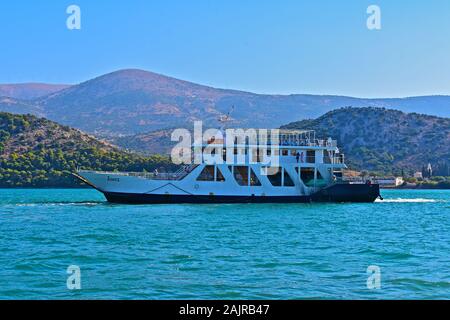 One of the local ferry boats, which provides a service between Argostoli and Lixouri, the main town on the peninsula of Paliki. leaving Argostoli. Stock Photo