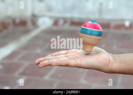 Classic wooden spinning top toy with string Stock Photo