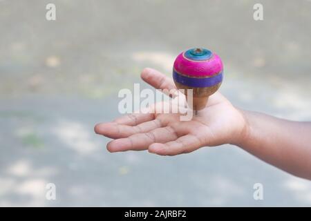 Classic wooden spinning top toy with string Stock Photo