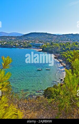 A stunning elevated view across a pretty bay near Lassi, looking towards Argostoli, with mountains in the background.  Tree in foreground. Stock Photo