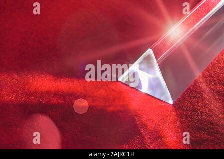 Glas prism on fire red background with lens flares Stock Photo