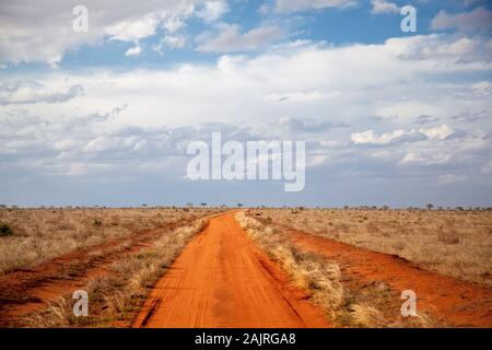 Red soil way, blue sky with clouds, scenery of Kenya