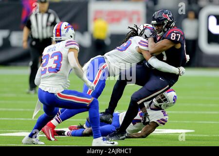 Houston, Texas, USA. 4th Jan, 2020. Houston Texans tight end Darren Fells (87) is tackled by Buffalo Bills middle linebacker Tremaine Edmunds (49) after a catch during the AFC Wild Card playoff game between the Houston Texans and the Buffalo Bills at NRG Stadium in Houston, TX on January 4, 2020. Houston won in overtime, 22-19, to advance to the AFC Divisional Round. Credit: Erik Williams/ZUMA Wire/Alamy Live News Stock Photo