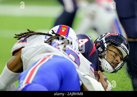 Houston, Texas, USA. 4th Jan, 2020. Houston Texans quarterback Deshaun Watson (4) is tackled by Buffalo Bills middle linebacker Tremaine Edmunds (49) during the AFC Wild Card playoff game between the Houston Texans and the Buffalo Bills at NRG Stadium in Houston, TX on January 4, 2020. Houston won in overtime, 22-19, to advance to the AFC Divisional Round. Credit: Erik Williams/ZUMA Wire/Alamy Live News Stock Photo