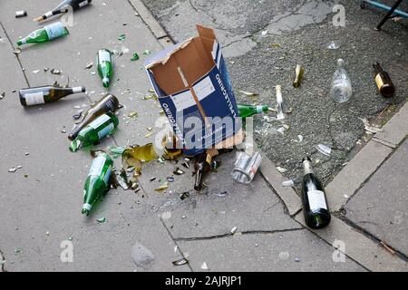 Cardboard box of glass bottles dropped and smashed on the street Stock Photo