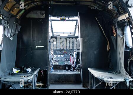 Interior of a Puma SA-330 XW241 helicopter or aircraft showing the cockpit and cabin with seats Stock Photo