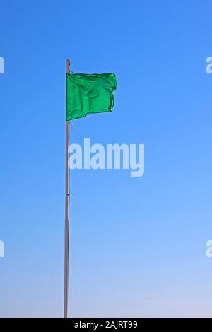 Green flag, green for go, beach flag, safe for bathing - low hazard, calm conditions
