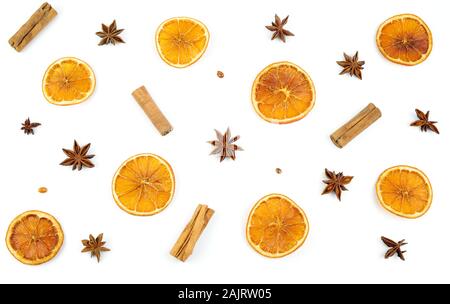 Concept of Christmas. Top view of pattern with dried orange slices, cinnamon and anise on white background. Winter composition. Stock Photo