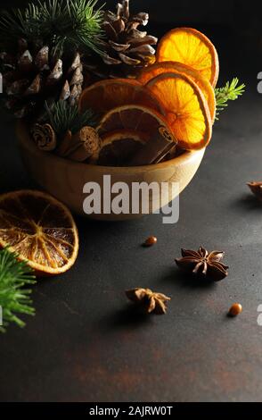 Concept of Christmas. Closeup of Christmas compositions with dried orange slices, cinnamon and anise on white background. Stock Photo