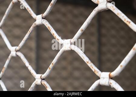 Security metal grilled rolling shutter. Old rusty metal grill white color texture background, Stock Photo