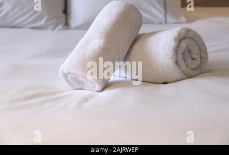 https://l450v.alamy.com/450v/2ajrwep/hotel-towels-white-fluffy-rolled-bath-towels-linen-sheets-and-pillows-on-a-bed-bedroom-interior-detail-close-up-view-2ajrwep.jpg