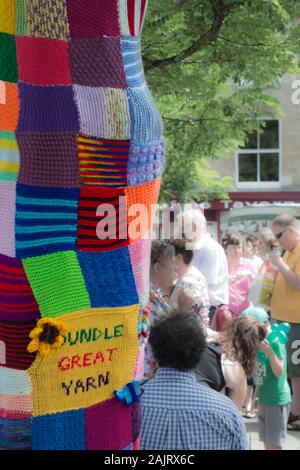 Oundle Great Yarn yarn bombing event with a yarn bombed tree in 2015 Stock Photo