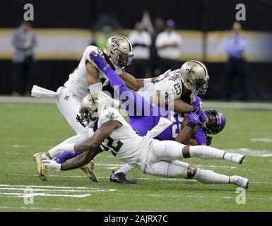 New Orleans, United States. 05th Jan, 2020. New Orleans Saints defenders wrap-up Minnesota Vikings running back Alexander Mattison (25) during the NFC Wild Card game in New Orleans on January 5, 2020. Photo by AJ Sisco/UPI Credit: UPI/Alamy Live News Stock Photo