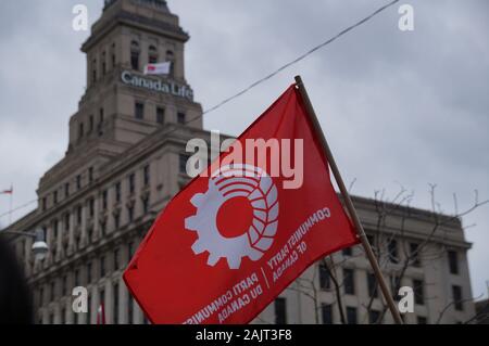 TORONTO, CANADA - 01 04 2020: Red flag of the Communist Party of Canada in front of the Canada Life building. Stock Photo