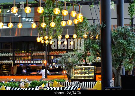 Istanbul Airport / Turkey - November 19 2019 Designer shops and Fast Food stores use bright neon signs and LED displays to tempt travellers Stock Photo