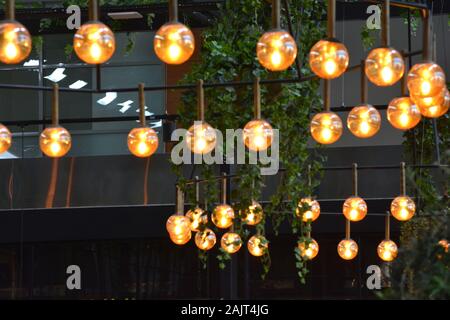 Istanbul Airport / Turkey - November 19 2019 Designer shops and Fast Food stores use bright neon signs and LED displays to tempt travellers Stock Photo